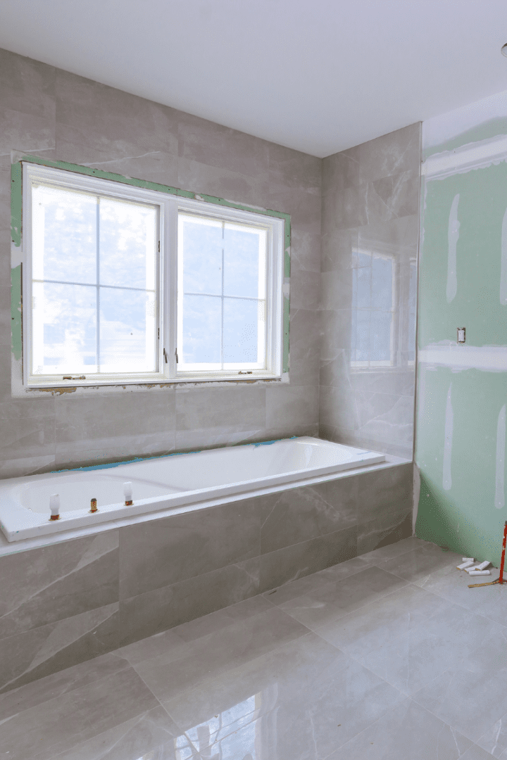 Untitled design (3) Bathroom renovation in progress with finished bathtub